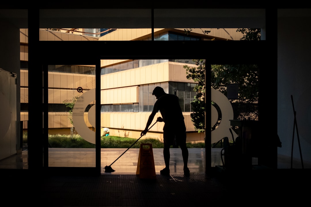 hero-img Man cleans floor at an entrance door.